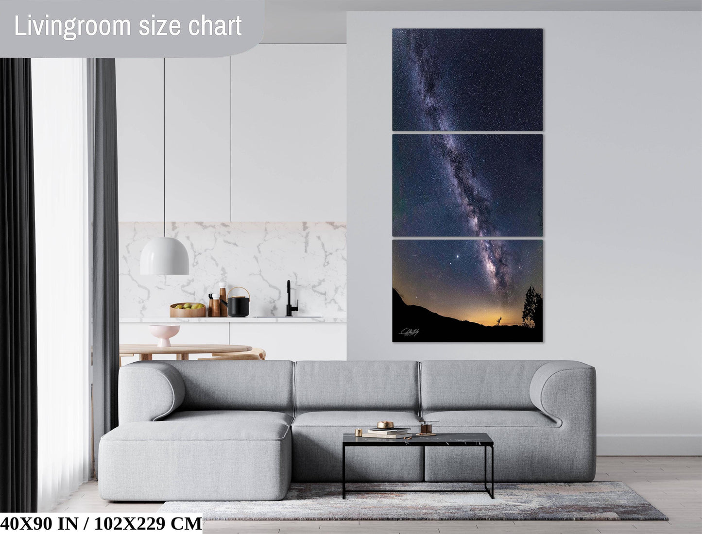 The image is a living room with a gray sofa, a coffee table, and a large wall art depicting a night sky with a galaxy.