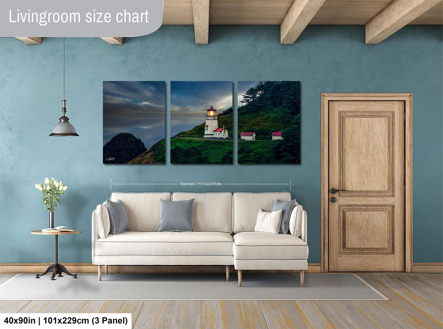 The image is a living room with a large white sofa and a wooden door. Above the sofa, there is a livingroom size chart that provides dimensions for the artwork displayed on the wall. The artwork is a collage of three pictures depicting a lighthouse on a hill.
