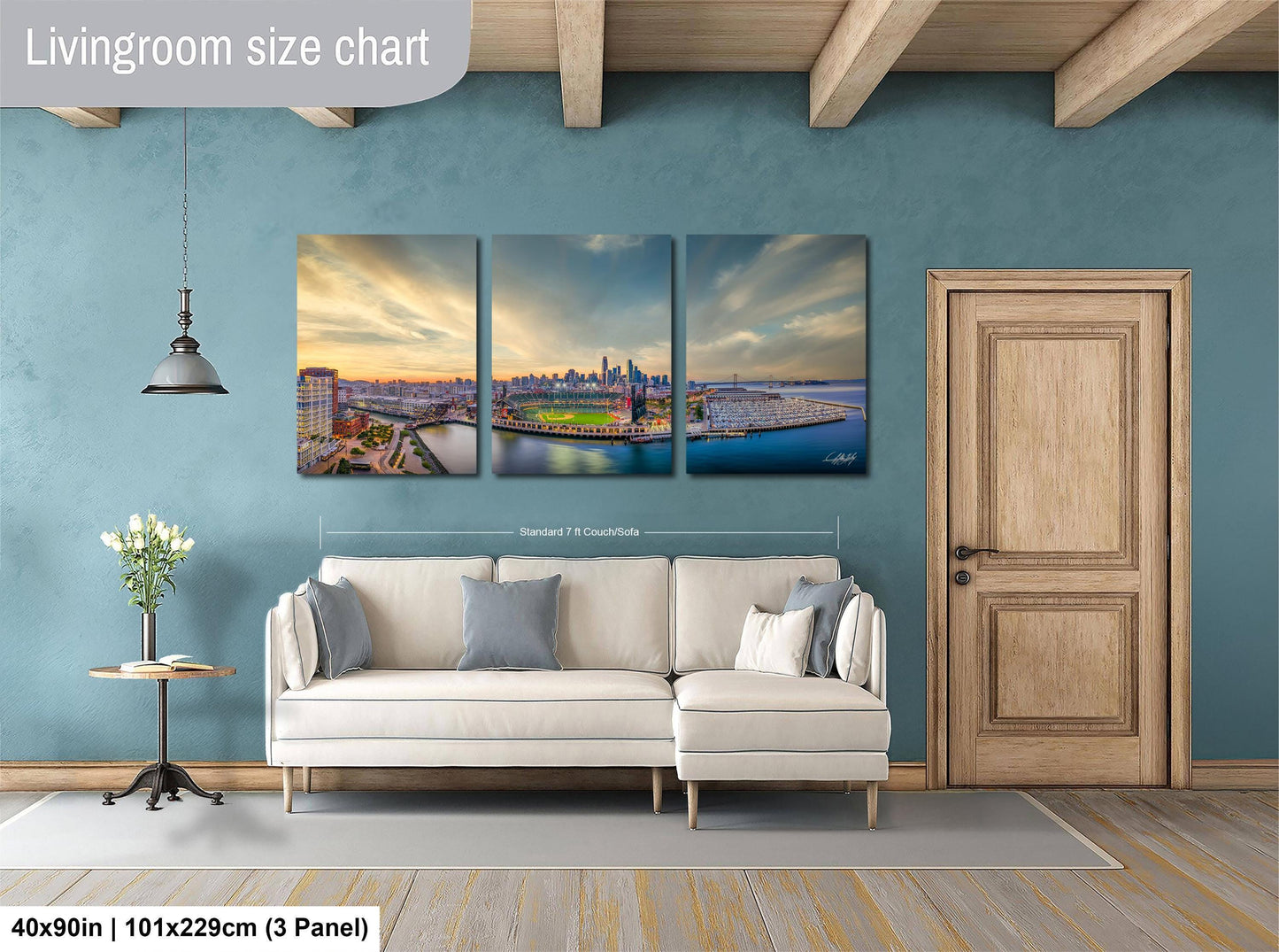 The image is a living room with a large white sofa, a wooden door, and a wall with a large living room size chart.