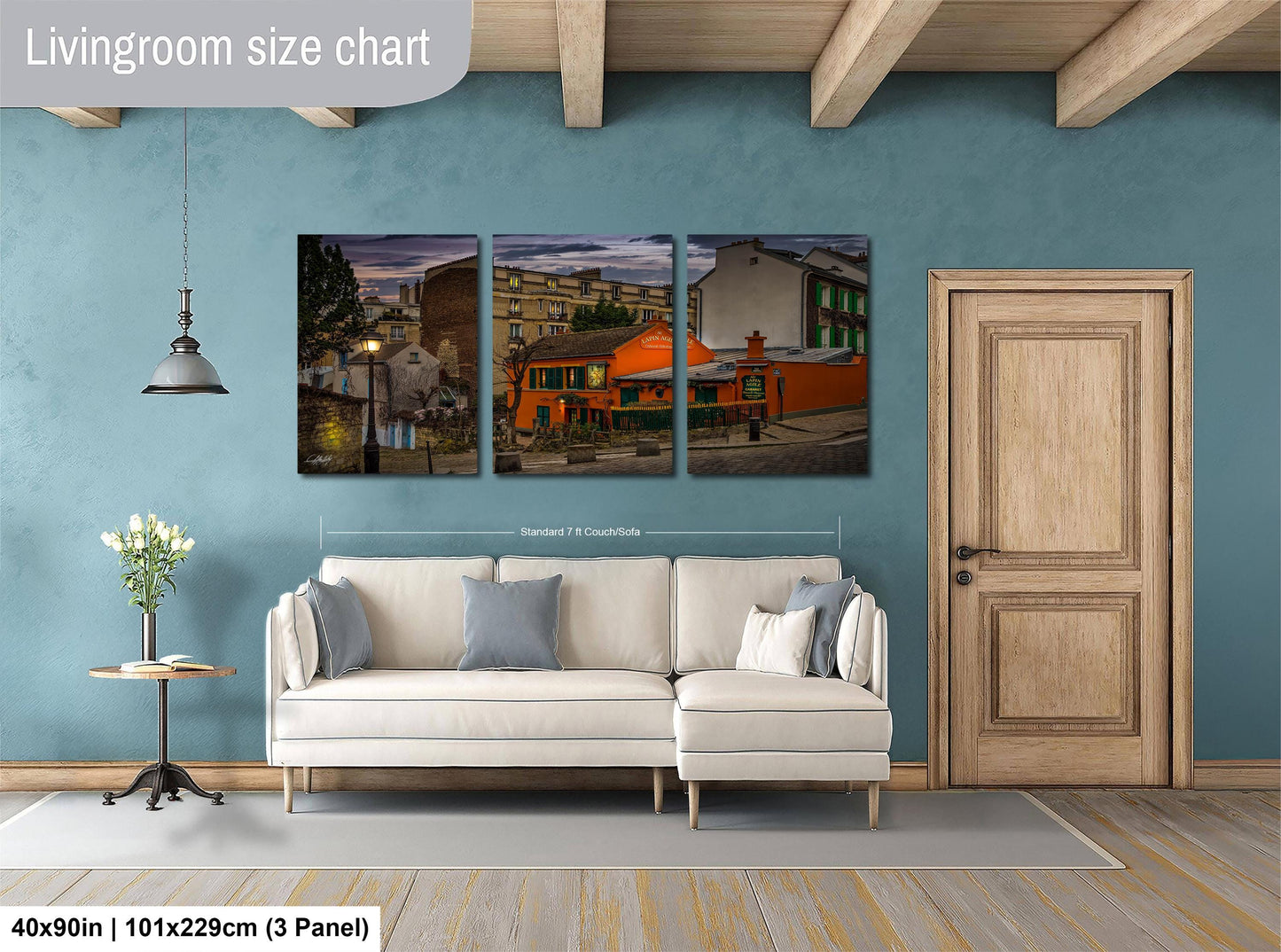 The image is a living room with a white sofa and a wooden door. Above the sofa, there is a living room size chart that provides dimensions for the artwork displayed on the wall.