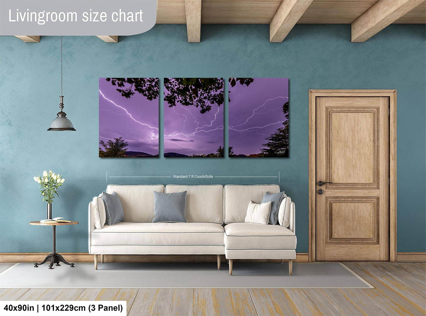 The image is a living room with a white sofa and a wooden door. Above the sofa, there is a large wall art depicting a purple sky with lightning. The wall art is divided into three panels, each showing a different part of the sky. The living room has a wooden floor and a wooden beam ceiling.