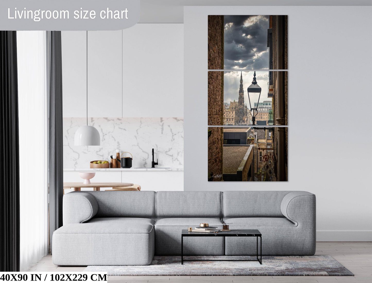 The image is a living room with a gray sofa, a coffee table, and a large window overlooking a city skyline.