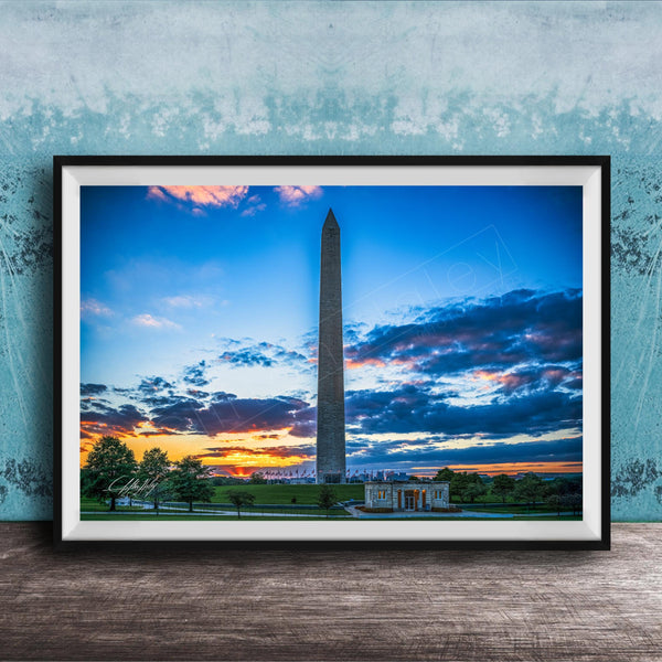 a photograph of the Washington Monument at sunset, with the sky filled with vibrant colors and clouds.