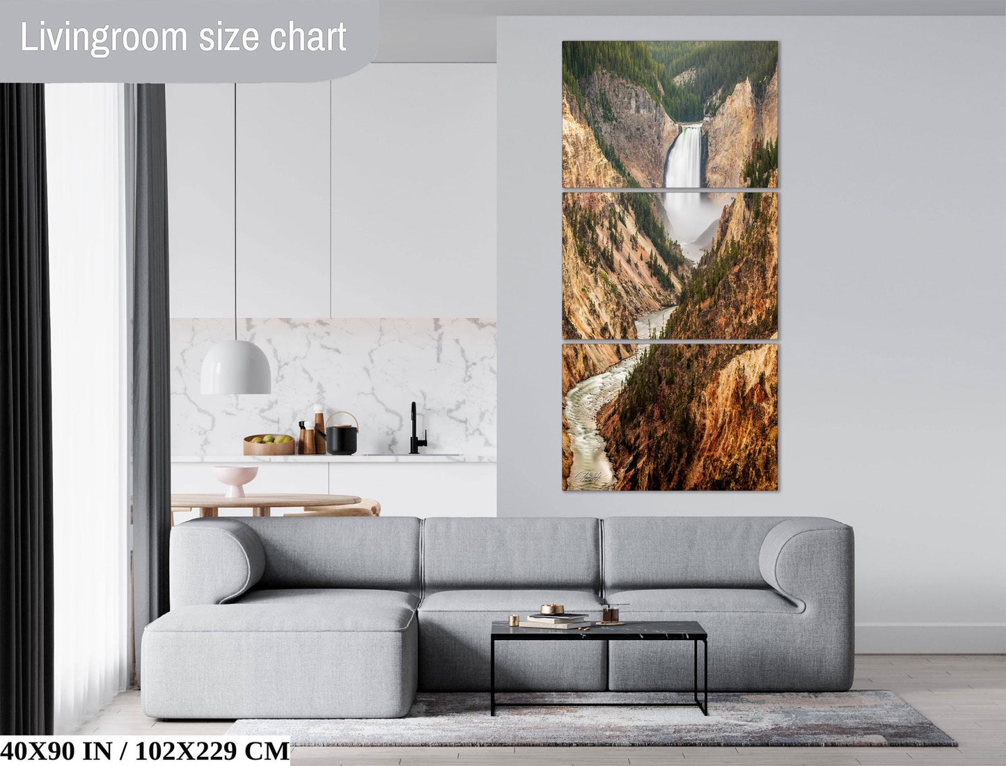 The image is a living room with a gray sofa, a coffee table, and a large wall art depicting a waterfall. The wall art is a three-piece collage, and the living room has a modern design with white walls and a marble countertop.