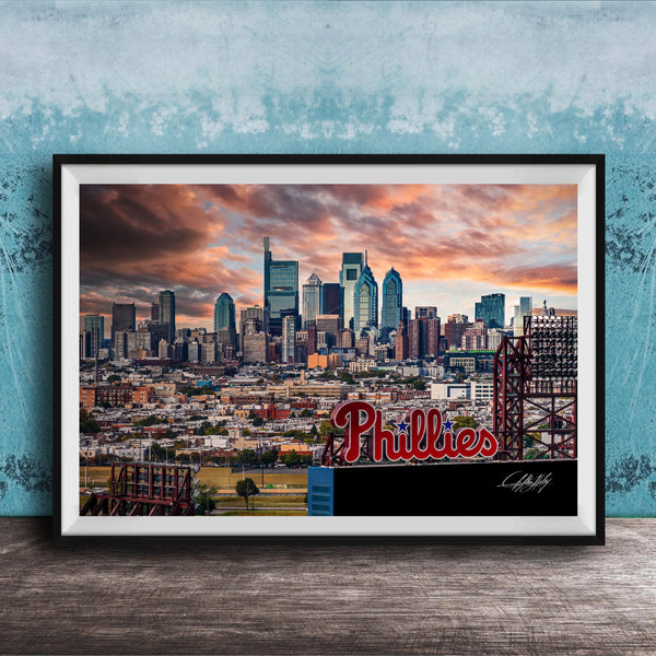 A framed photograph of the Philadelphia skyline at sunset, with the word "Phillies" prominently displayed in the foreground.