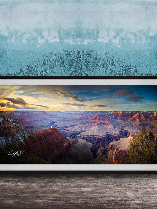 A framed photograph of the Grand Canyon, showcasing the vast and breathtaking landscape with its dramatic rock formations and vibrant colors at sunset.