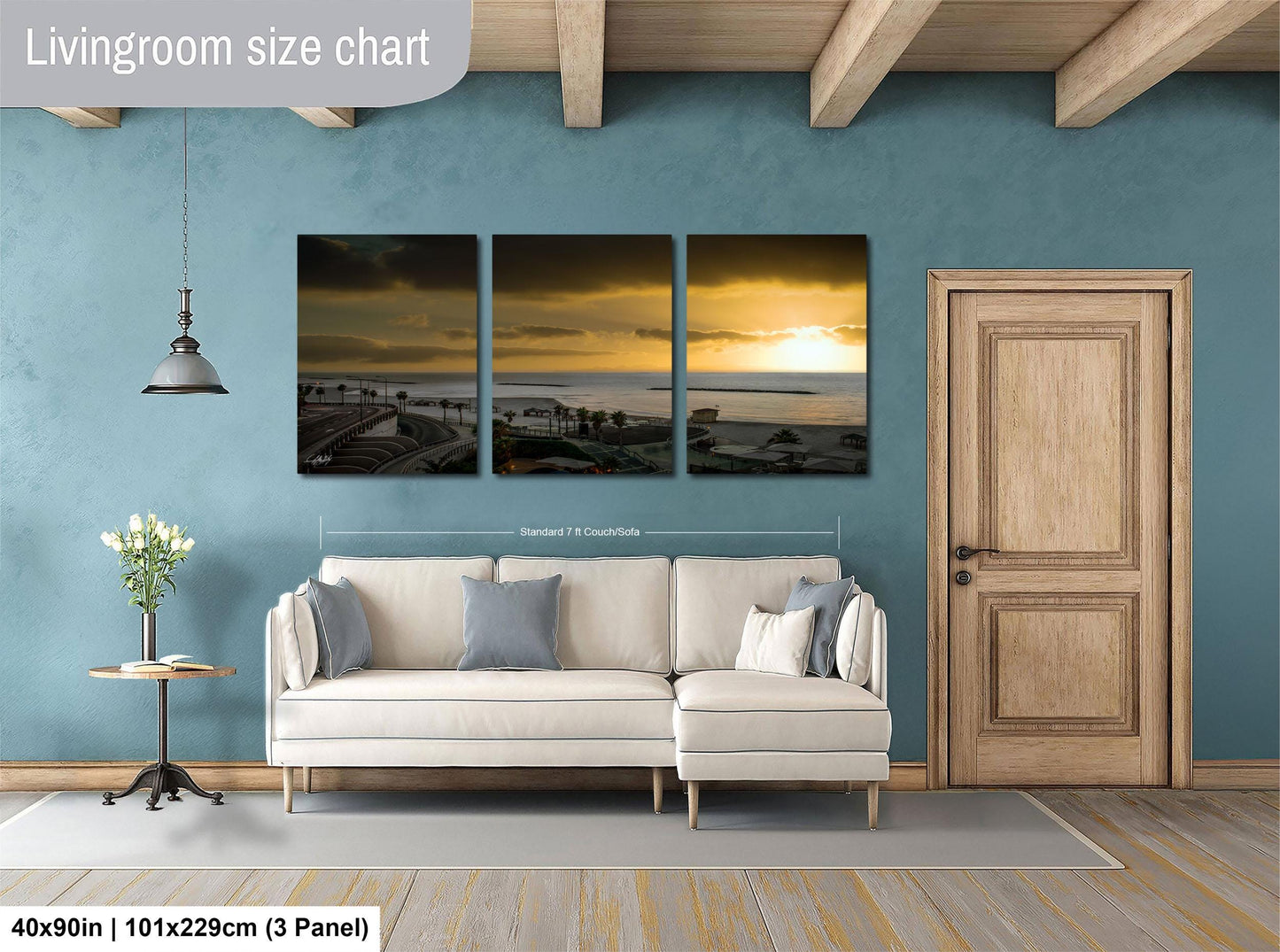 The image is a living room with a white sofa and a wooden door. Above the sofa, there is a living room size chart that provides dimensions for the artwork displayed on the wall.