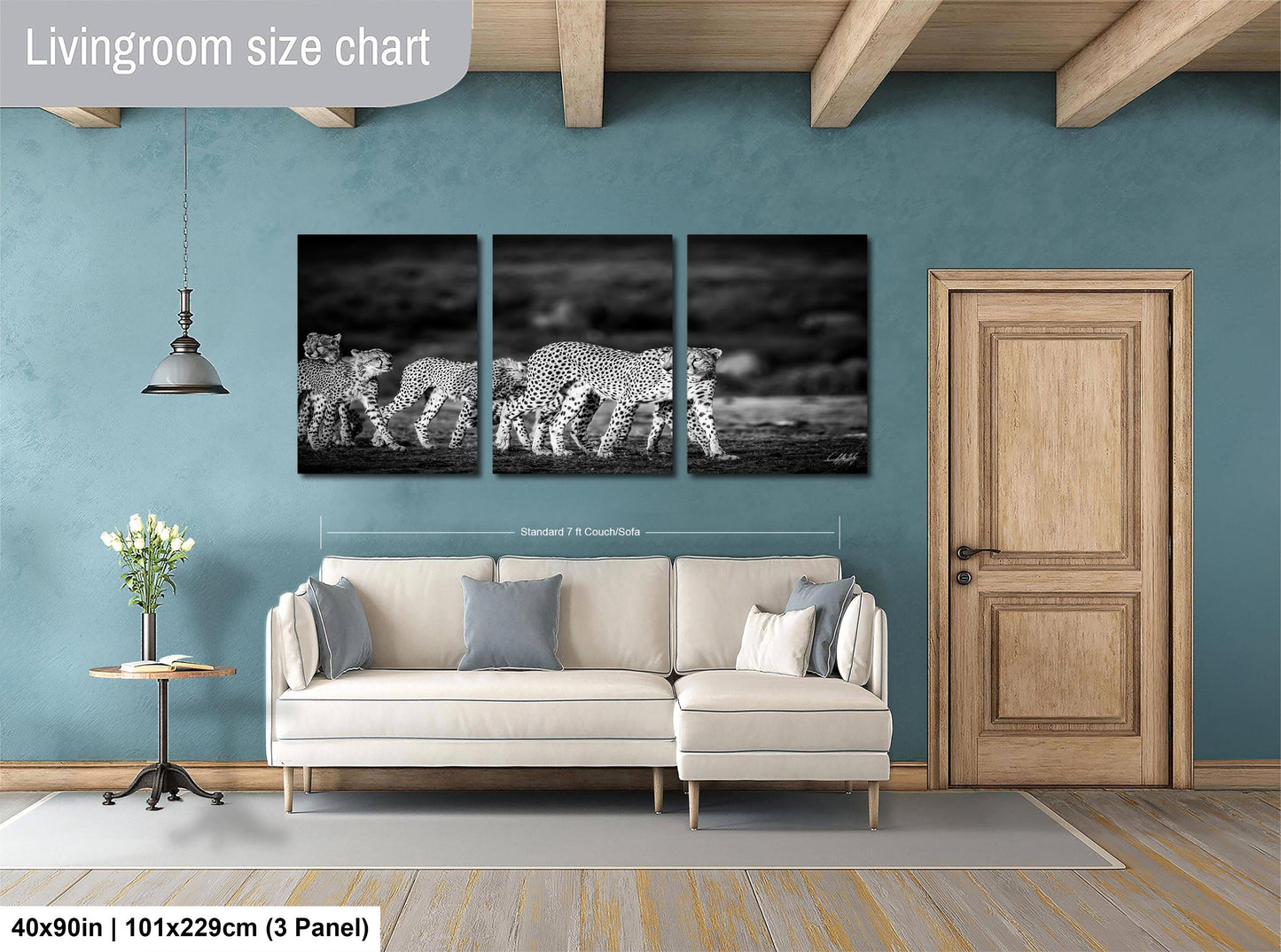 The image is a living room with a large wall art depicting a group of leopards walking across a field. The wall art is divided into three panels, each showing a different stage of the leopard's movement. The living room has a white sofa and a wooden door, creating a cozy and elegant atmosphere.