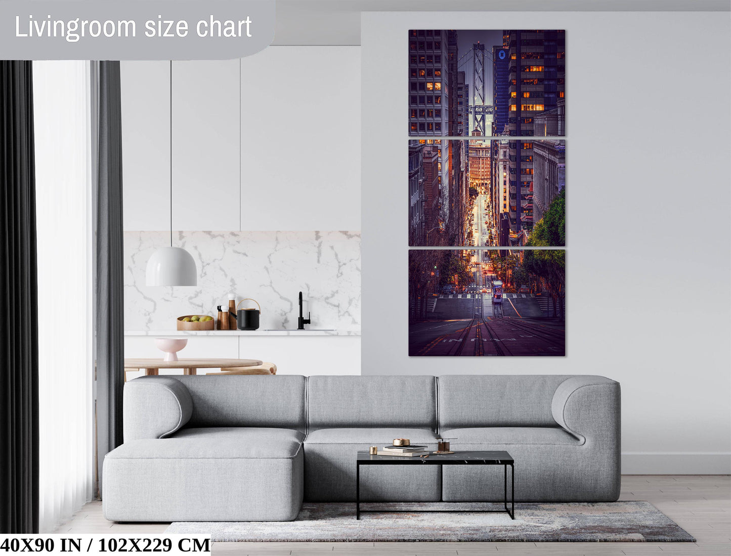 The image is a living room with a gray sofa, a coffee table, and a large wall art depicting a cityscape at night.