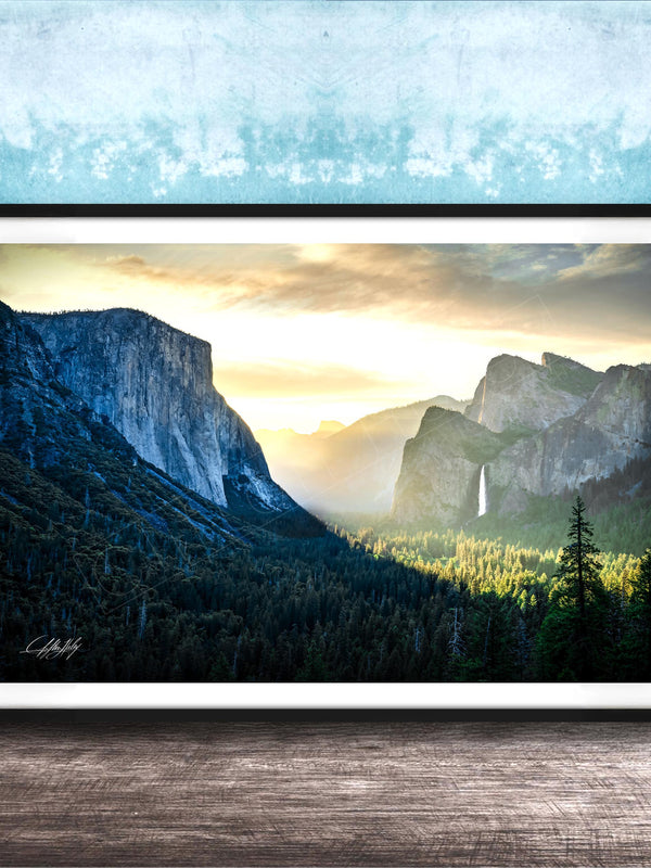 The image is a framed photograph of a scenic mountain landscape with a waterfall, set against a blue and white background.