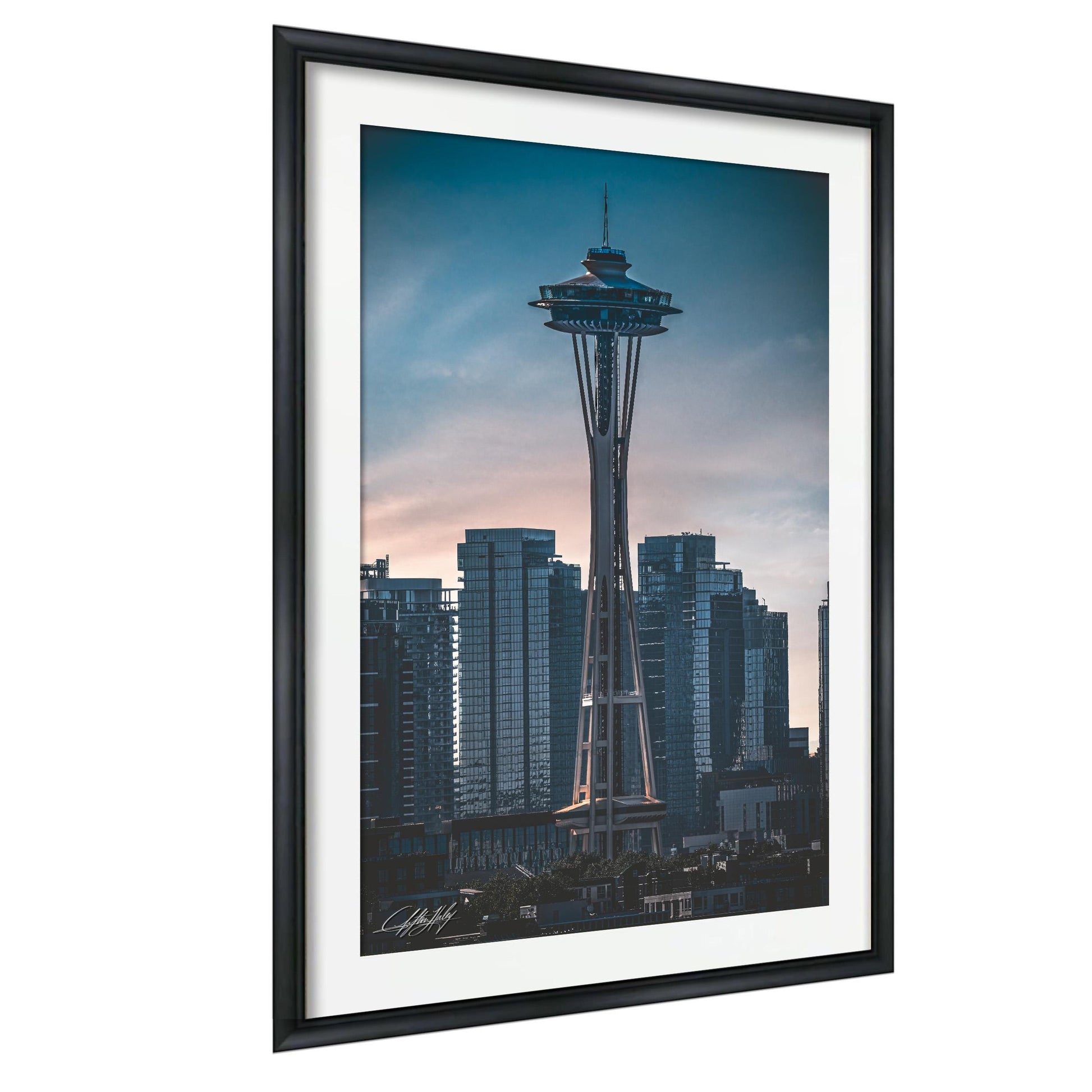 A framed photograph of the Space Needle, a famous landmark in Seattle, Washington, with the city skyline in the background.