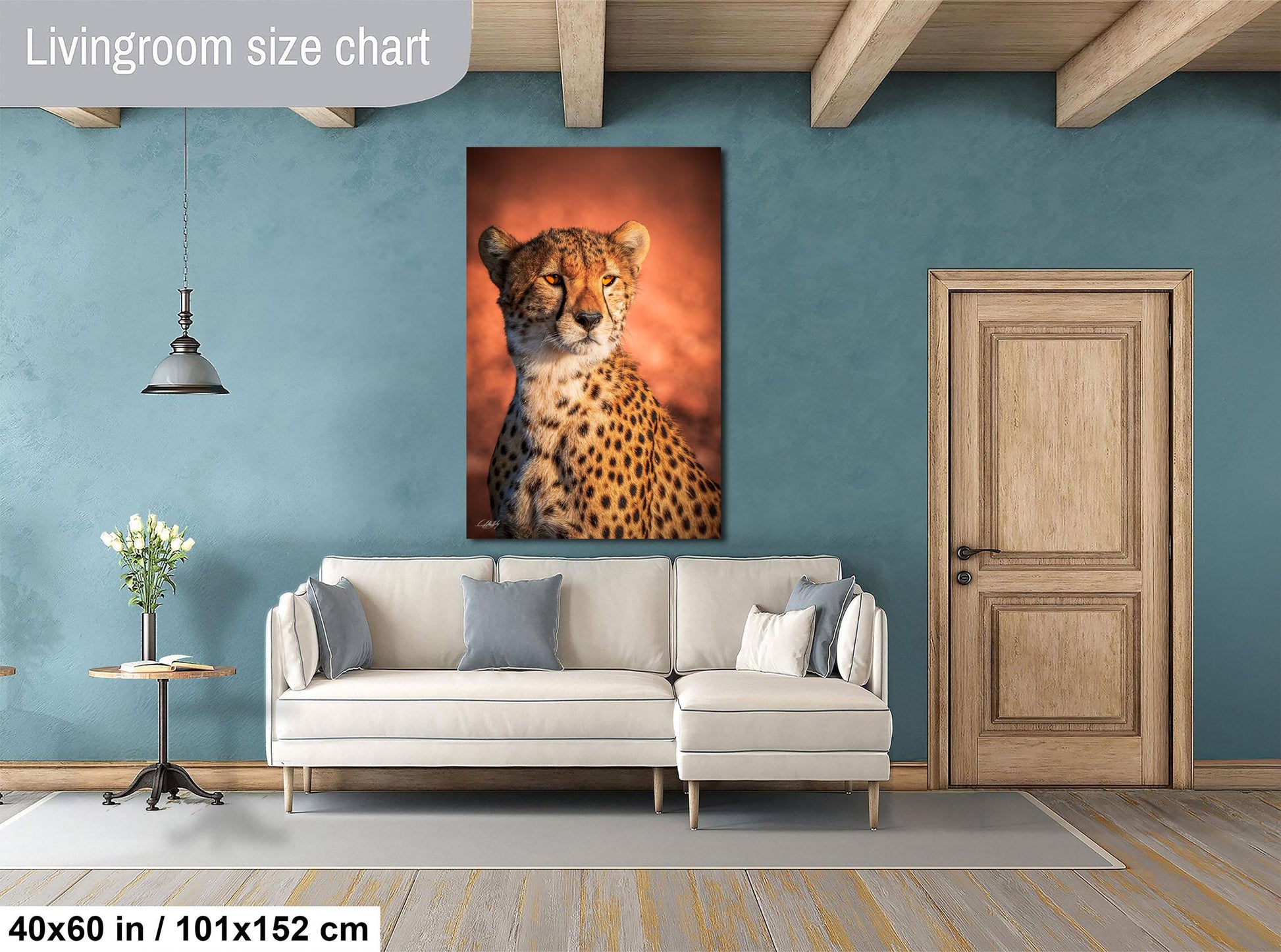a living room with a large white sofa, a wooden door, and a framed photograph of a cheetah on the wall.