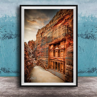 a carved doorway in a canyon, with a dramatic sky in the background.