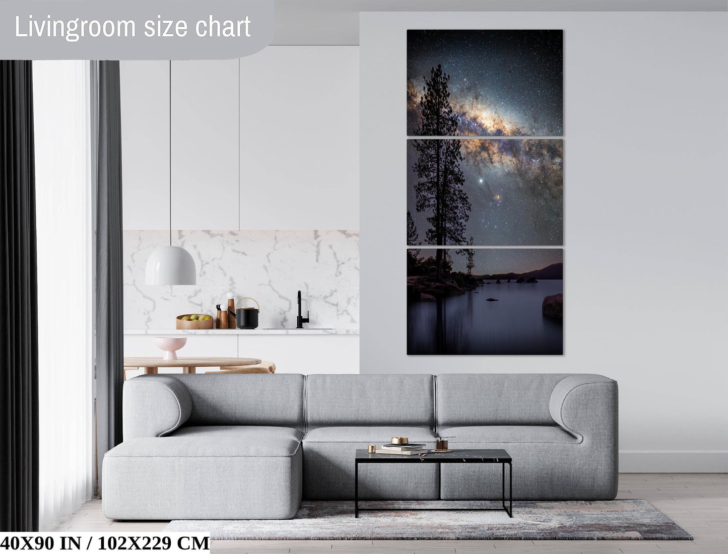 The image is a living room with a gray sofa, a coffee table, and a large wall art depicting a night sky with a galaxy.
