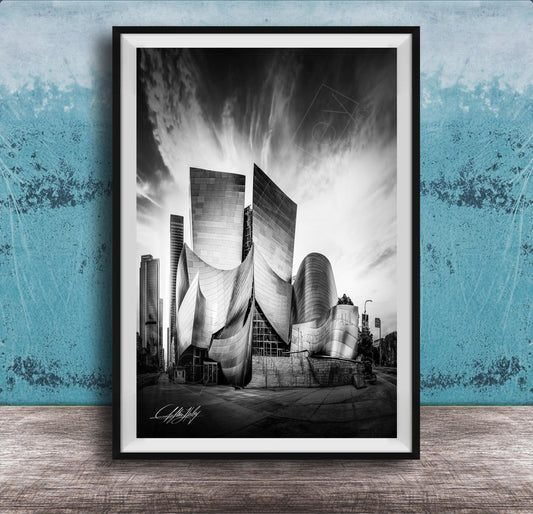 A black and white photograph of a modern, curved building with a distinctive architectural design, set against a cloudy sky.