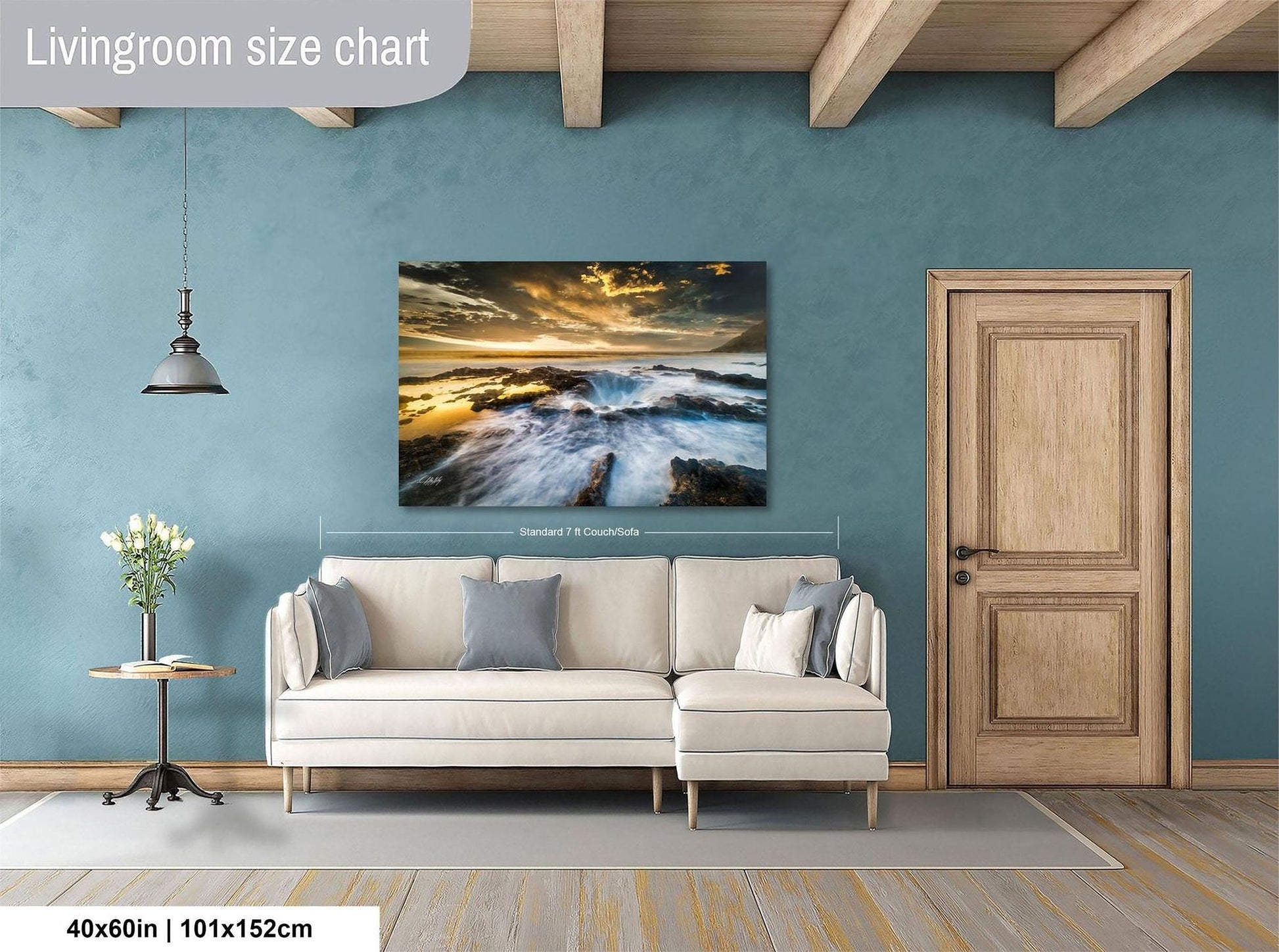 a living room with a large painting of a seascape hanging on the wall. The painting is framed in white and measures 40 inches by 101.5 centimeters. The room has a wooden door and a white sofa, creating a cozy and inviting atmosphere.