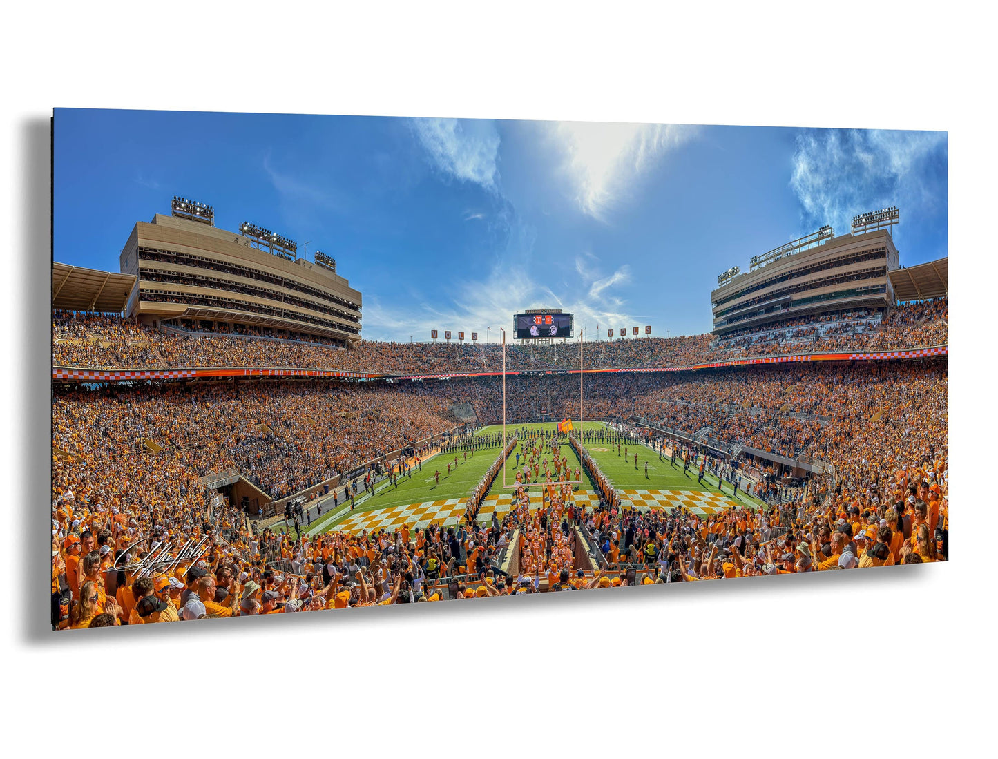 A panoramic view of a crowded football stadium with a large audience, a large field, and a scoreboard visible in the center of the image.
