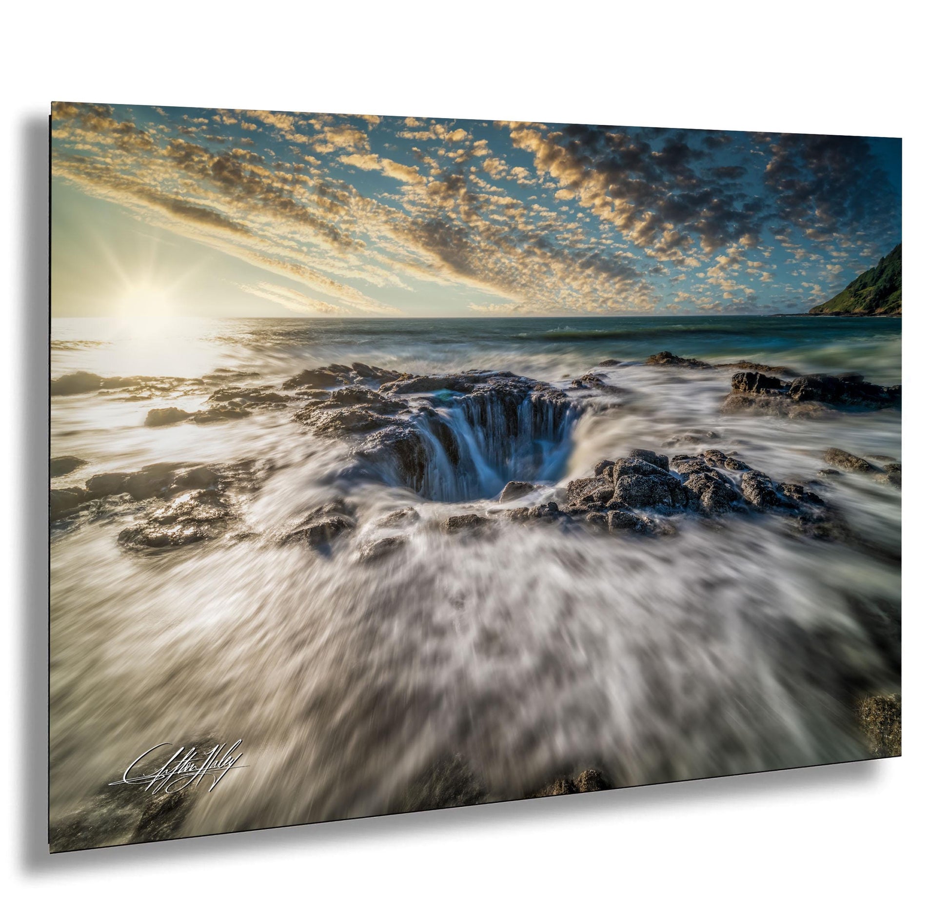 a dramatic natural landscape with a powerful waterfall cascading into a deep chasm below, surrounded by rocky terrain and a vibrant sky with clouds.