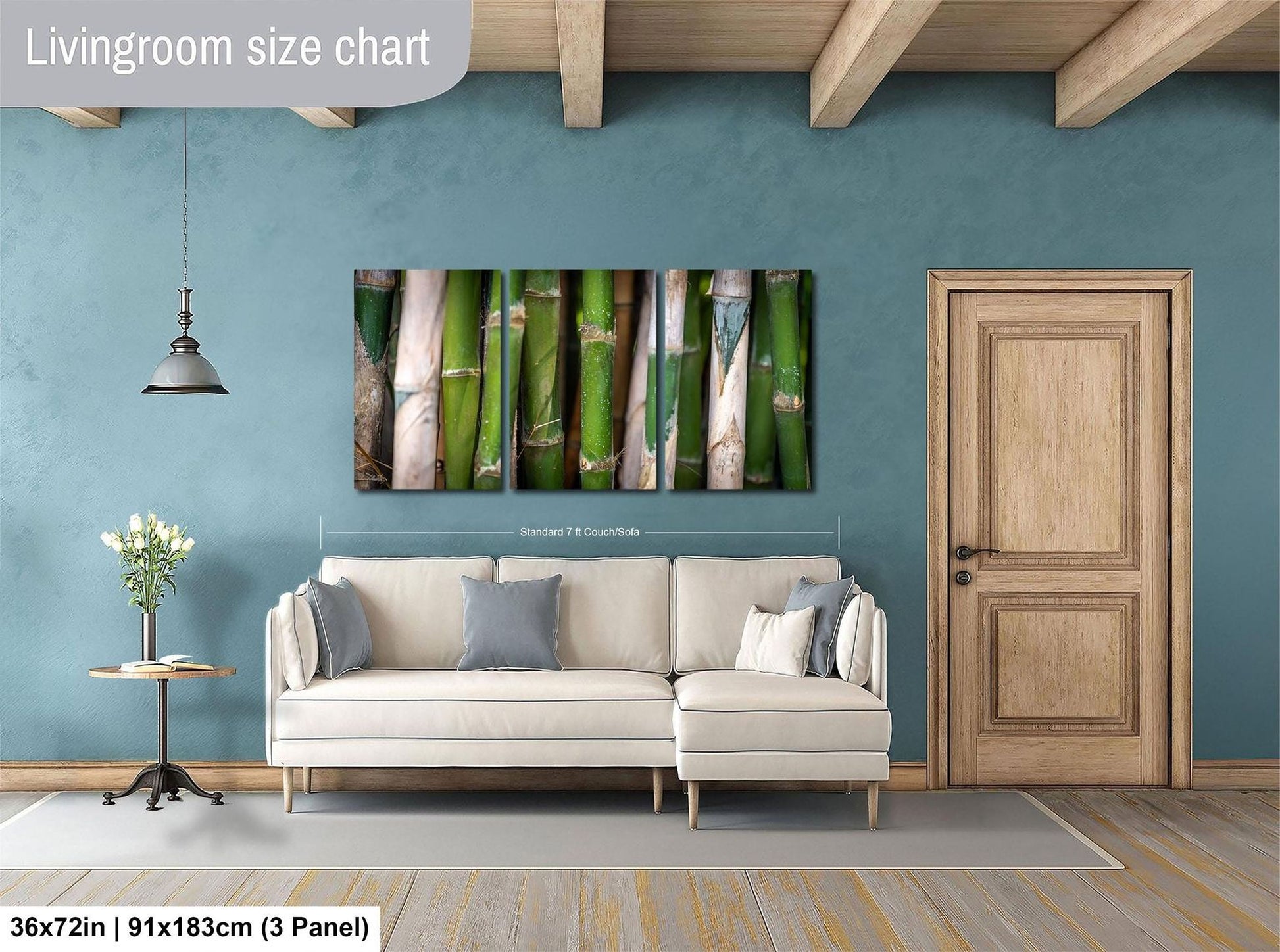 a living room with a large wall art piece featuring a row of bamboo stalks. The living room has a white sofa, a wooden door, and a wooden floor. The wall art is approximately 36 inches wide and measures approximately 91 inches tall.