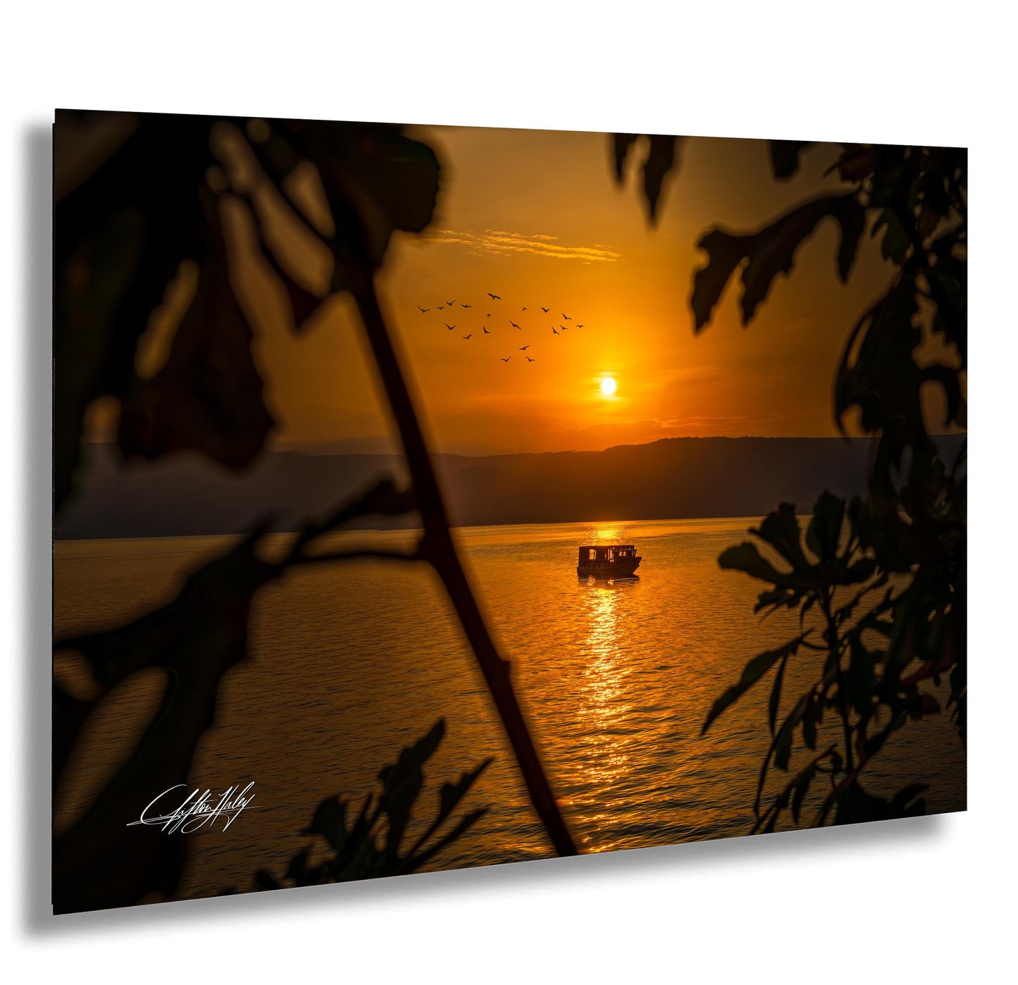 a serene sunset over a body of water, with a boat gently floating on the surface.