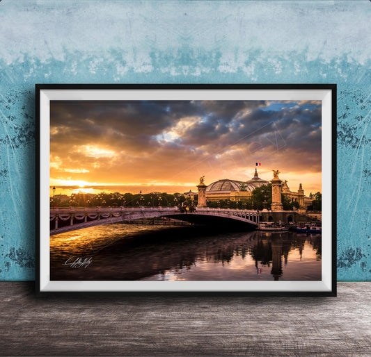 a picturesque scene of a bridge spanning a river, with a large domed building on the other side. The sky is filled with vibrant colors, suggesting either sunrise or sunset, and the water below reflects the stunning hues. The overall composition and the presence of the domed building create a sense of grandeur and beauty in the scene.