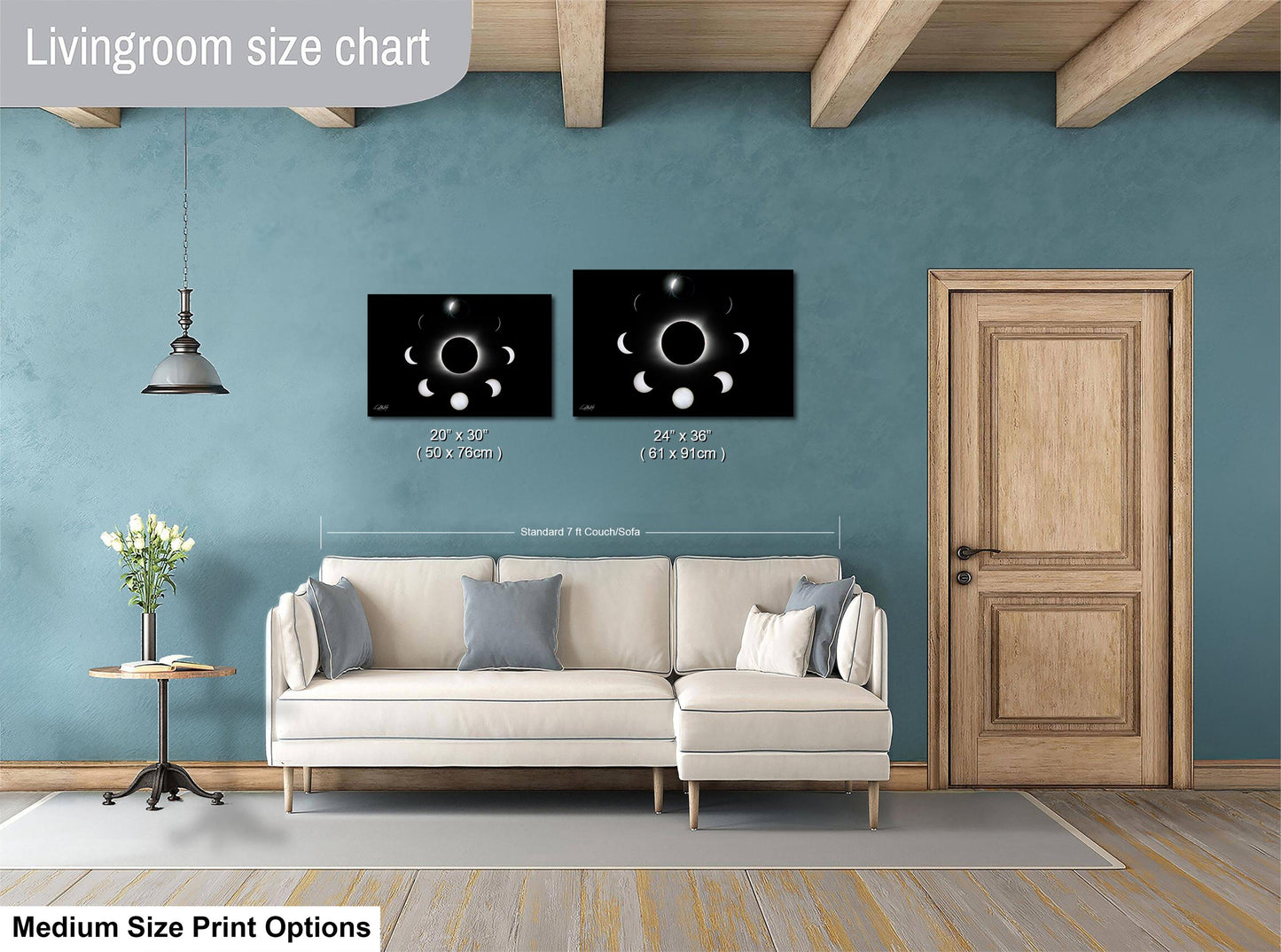 a living room with a white sofa, a wooden door, and a framed artwork depicting the phases of the moon hanging on the wall.