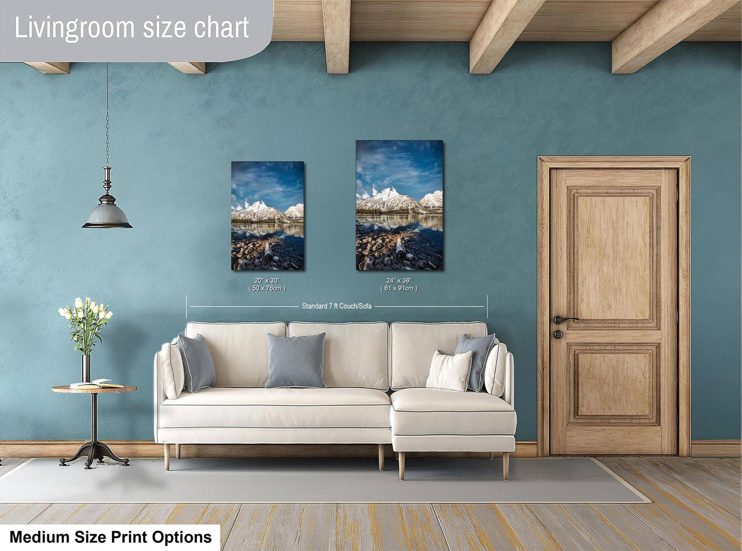 a living room with a white sofa, a wooden door, and a painting of a mountain landscape on the wall.