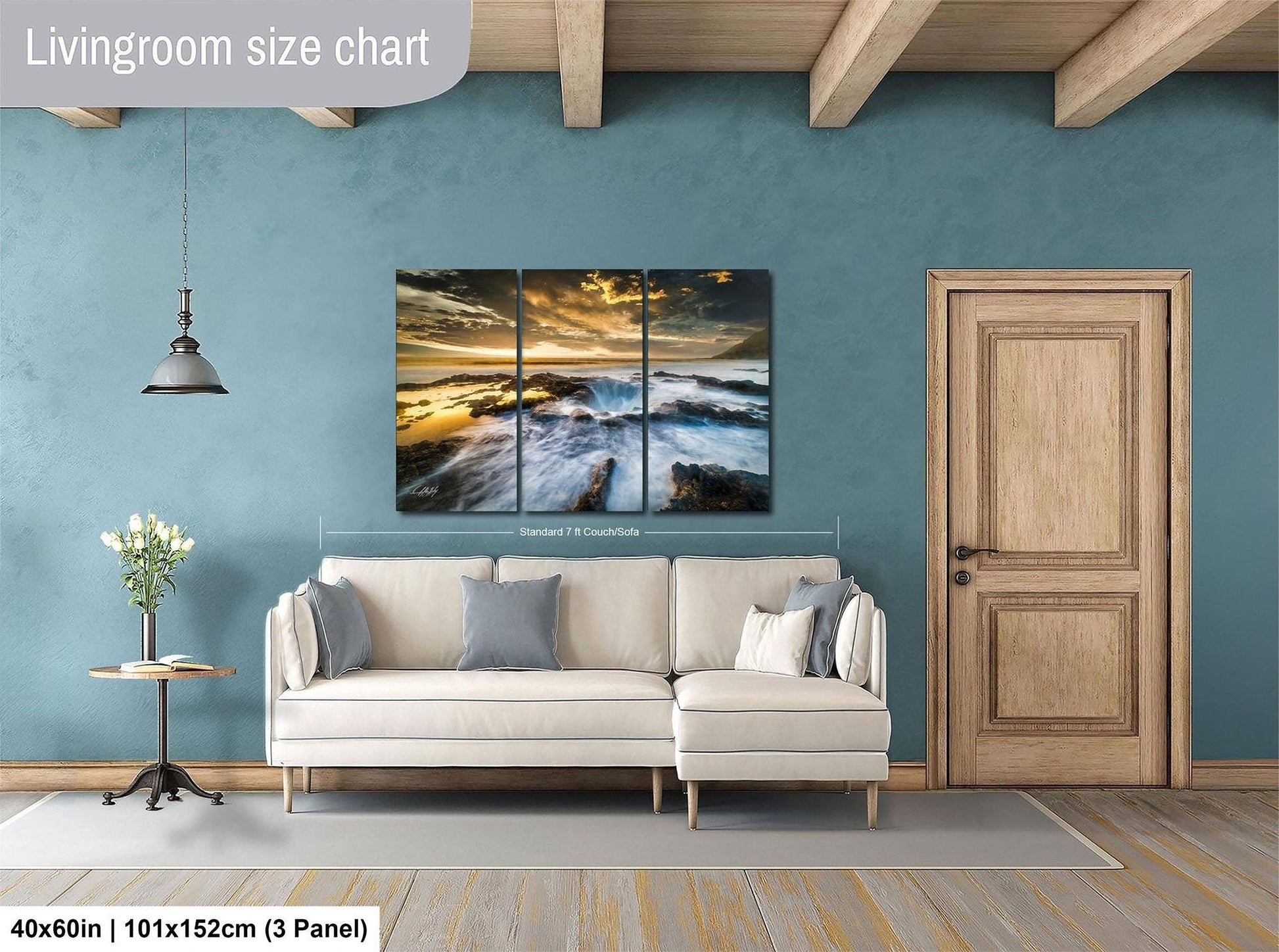 The image is a living room with a large, three-panel landscape painting hanging on the wall. The painting depicts a serene beach scene with waves crashing against the shore. The room features a white sofa, a wooden door, and a small table with a vase of flowers. The living room size chart indicates that the space is approximately 40'x60', with a total height of 101'x152'', and a width of 3' panel.