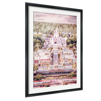 A framed painting depicting a fantastical, castle-like structure surrounded by a lush, mountainous landscape.