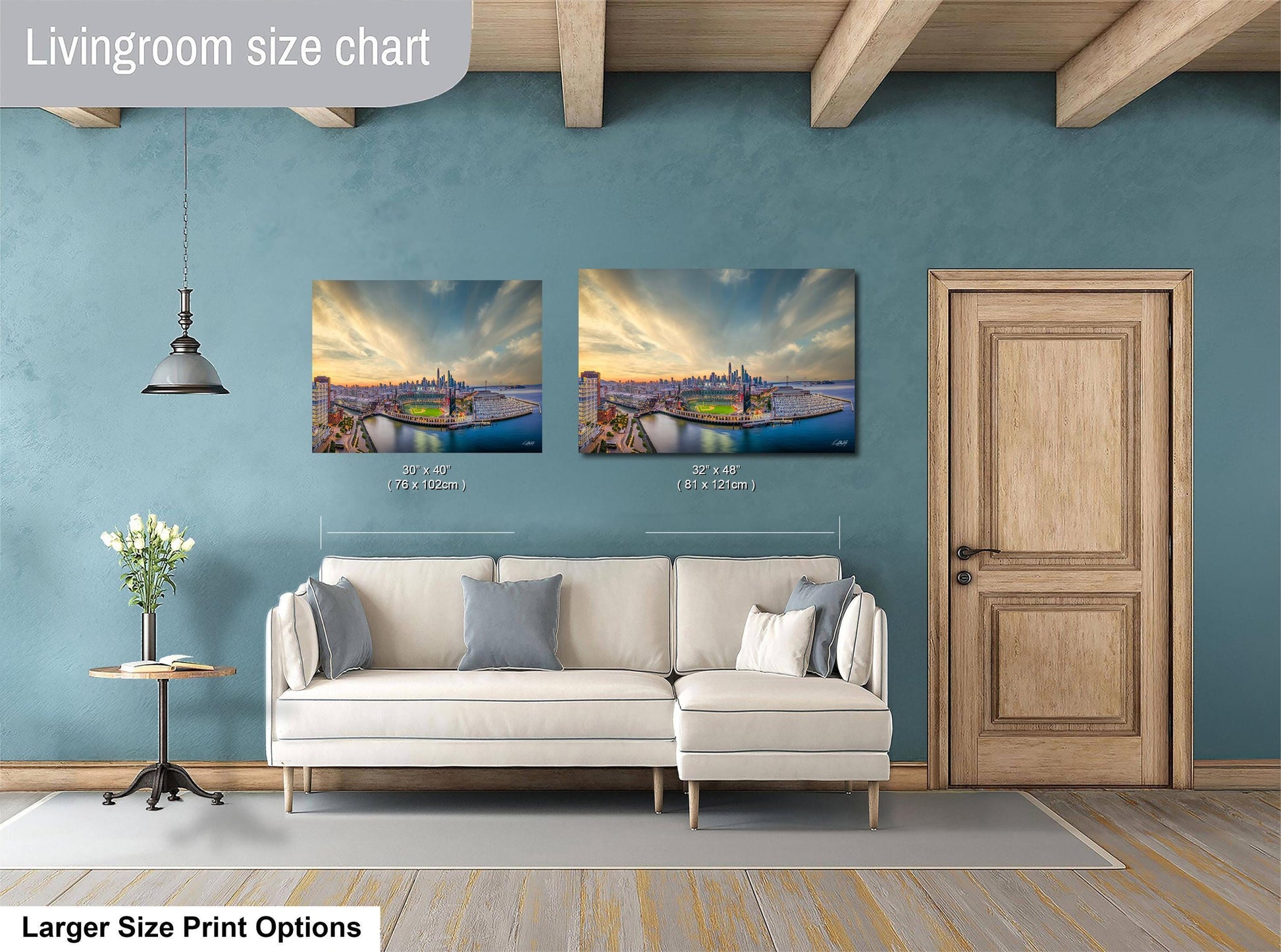 a living room with a white sofa, a wooden door, and two framed pictures of a cityscape hanging on the wall.