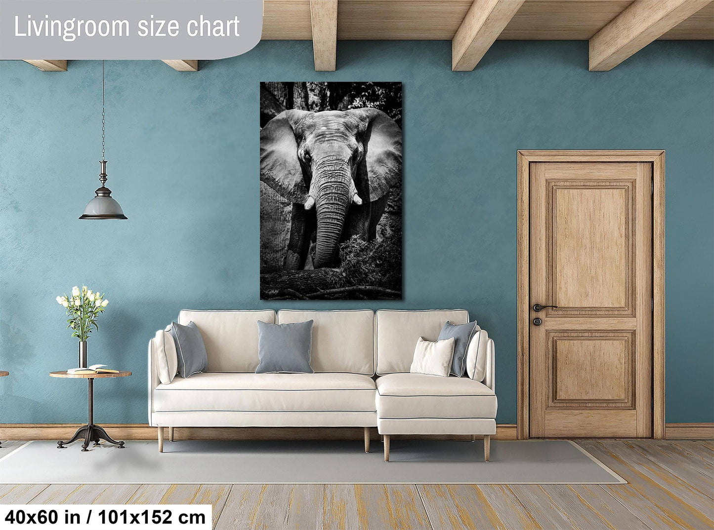 a living room with a large elephant painting hanging on the wall above a white sofa.