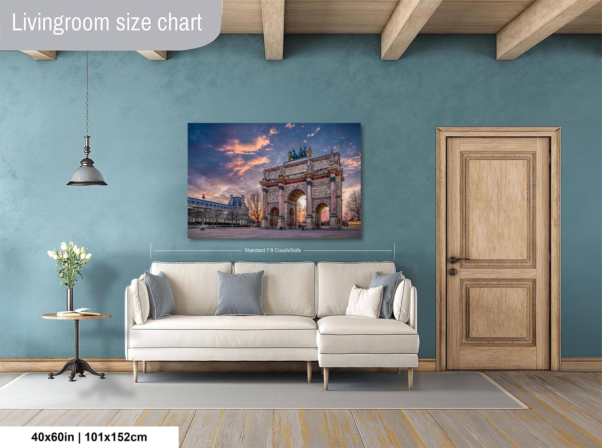 a living room with a large wall-mounted painting depicting the Arc de Triomphe in Paris, France. The painting is framed and hangs above a white sofa. The room has a wooden door and a small table with a vase of flowers. The wall has a blue color, and the floor is made of wood.