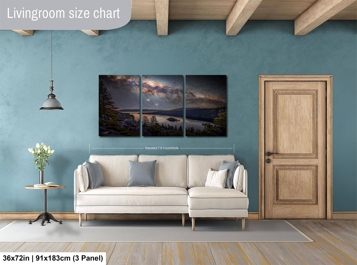The image is a living room with a large, three-panel landscape painting hanging on the wall. The painting depicts a serene night sky with a lake and mountains in the background. The room has a white sofa and a wooden door, creating a cozy and inviting atmosphere.