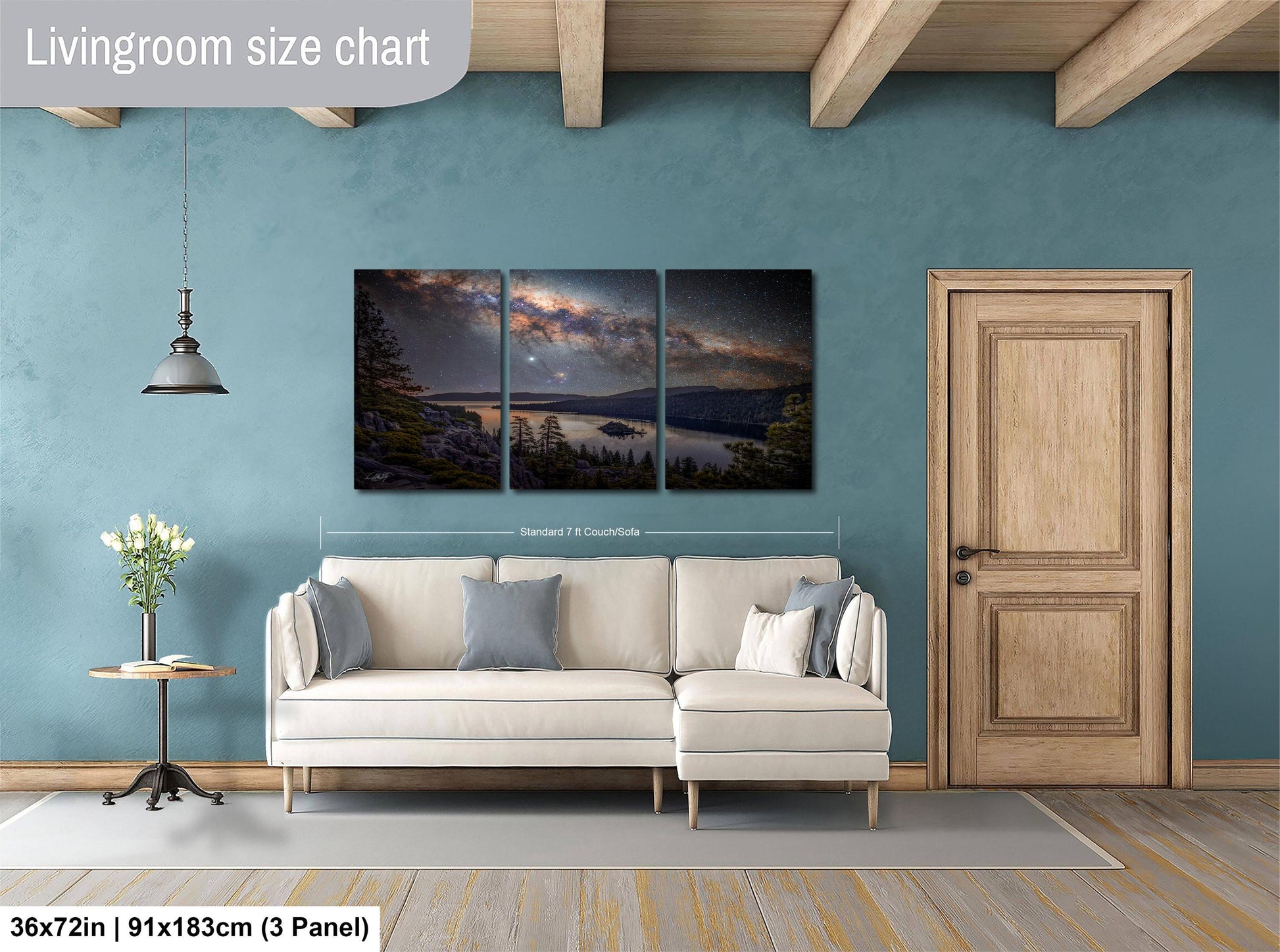 The image is a living room with a large, three-panel landscape painting hanging on the wall. The painting depicts a serene night sky with a lake and mountains in the background. The room has a white sofa and a wooden door, creating a cozy and inviting atmosphere.