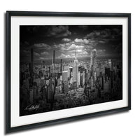 A black and white photograph of the New York City skyline, featuring the iconic Empire State Building and other skyscrapers.
