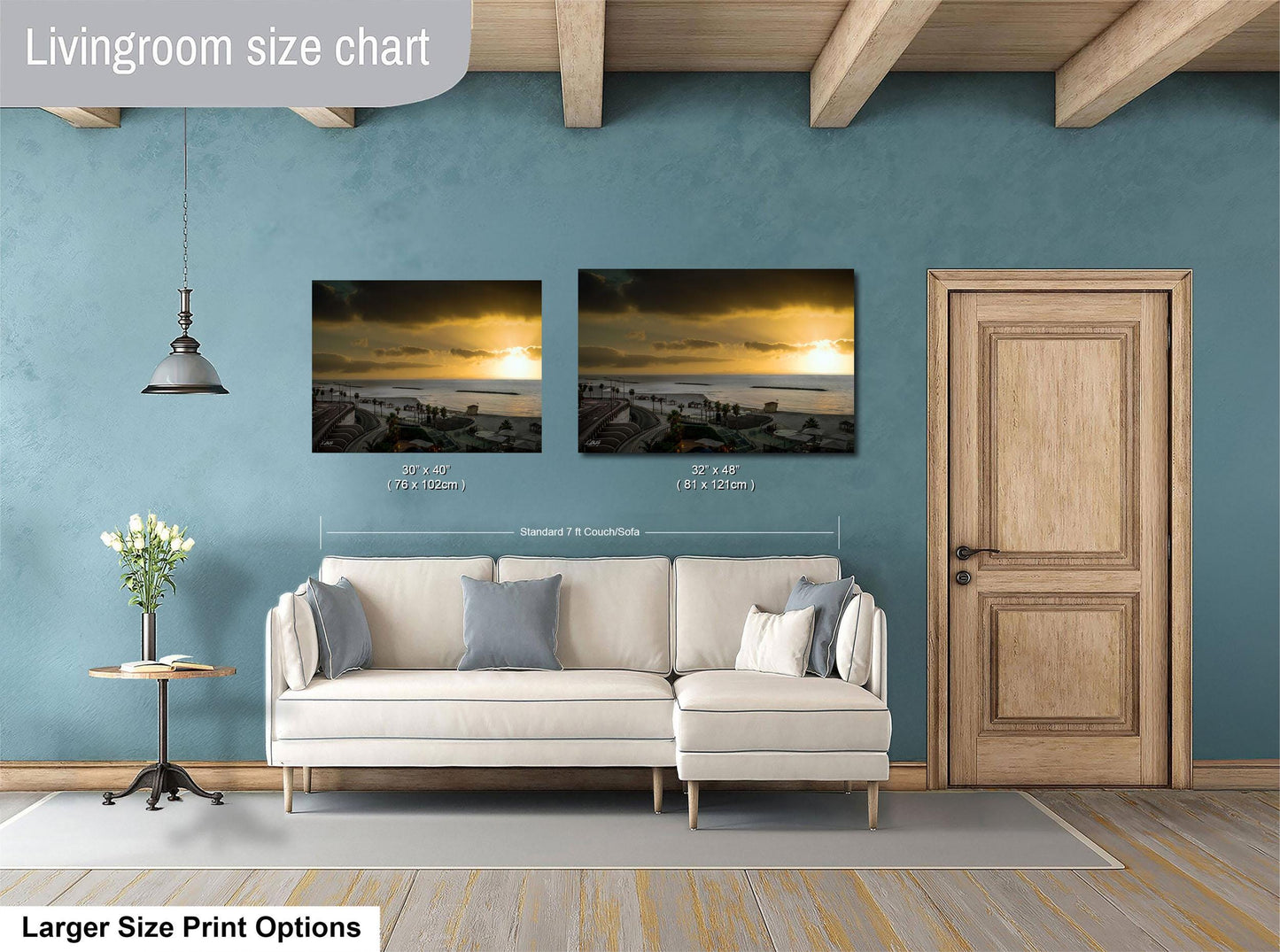 a living room with a white sofa, a wooden door, and two framed pictures hanging on the wall. The living room appears to be modern and well-decorated.