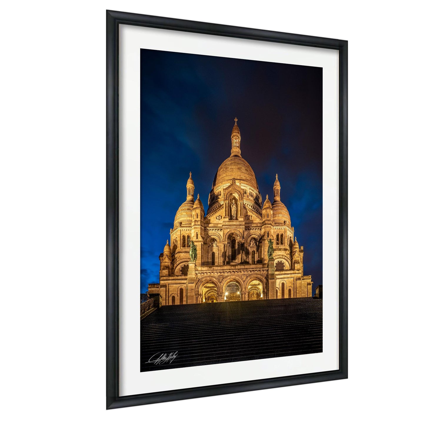 a large, ornate cathedral with multiple domes and arches, illuminated at night against a dark sky.