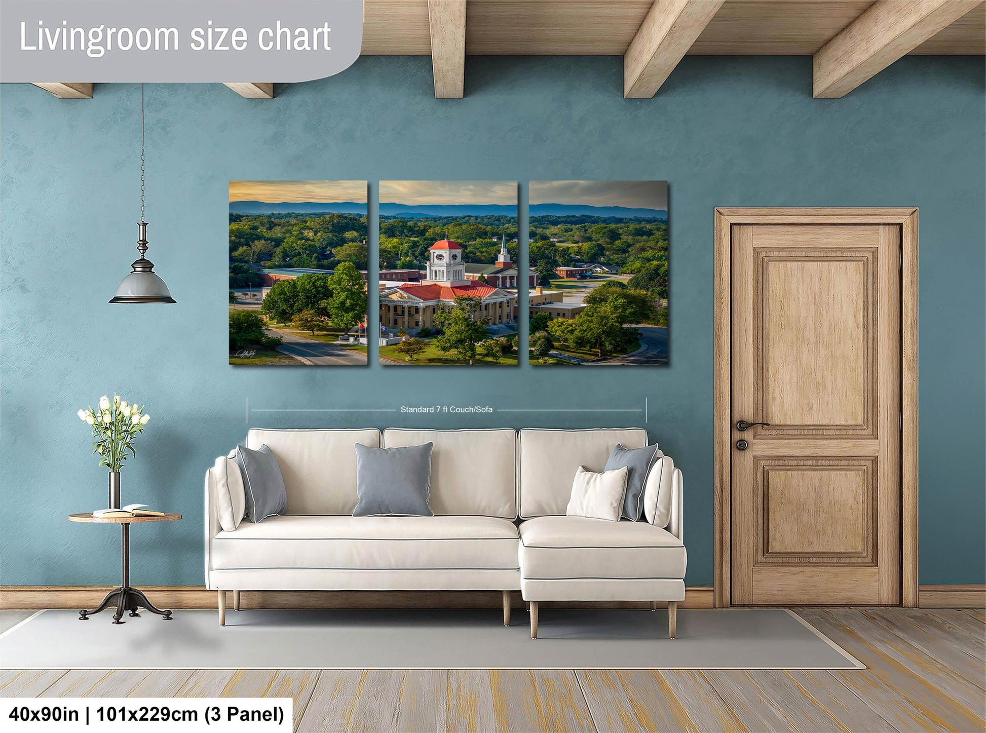 The image is a living room with a large, three-panel living room size chart on the wall. The chart displays the dimensions of the living room in feet and inches, with the largest panel measuring 40'x50'', the medium panel measuring 101'x129'', and the smallest panel measuring 3'x3''.