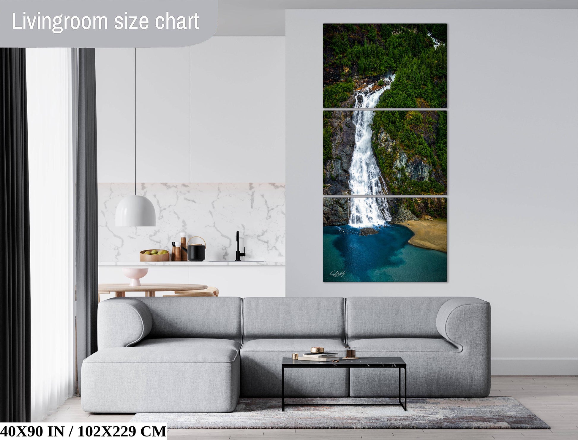 The image is a living room with a gray sofa, a coffee table, and a large painting of a waterfall on the wall.