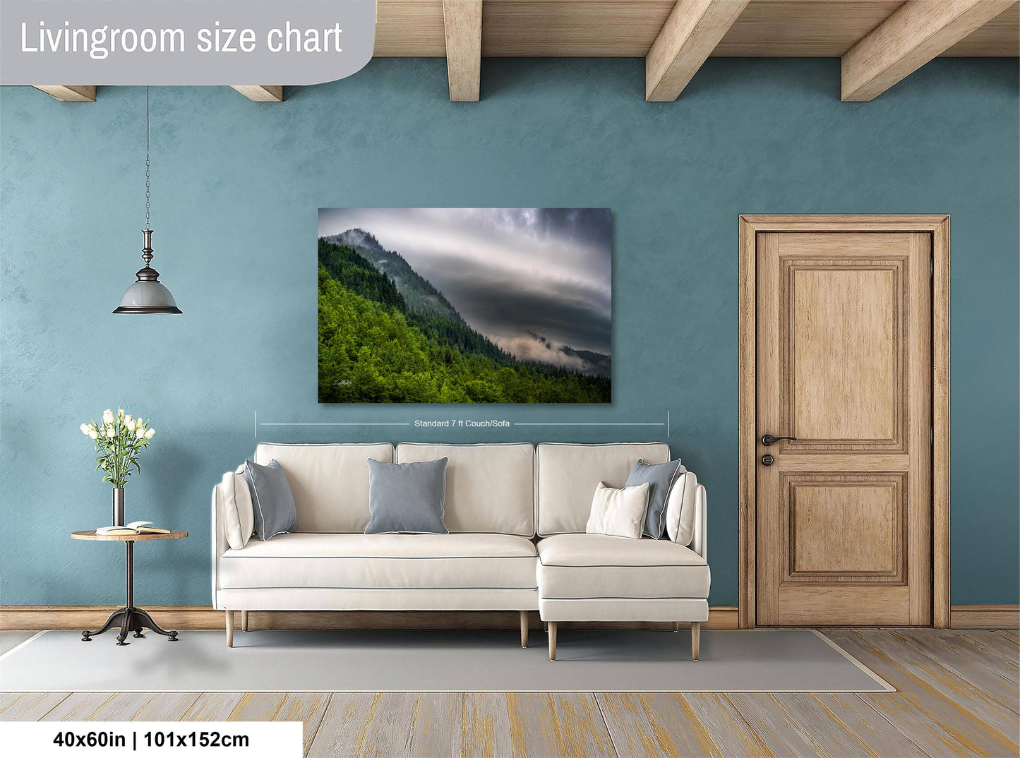 a living room with a large landscape painting hanging on the wall, depicting a mountain scene with clouds. The painting is framed and measures 40 inches by 101.5 centimeters.