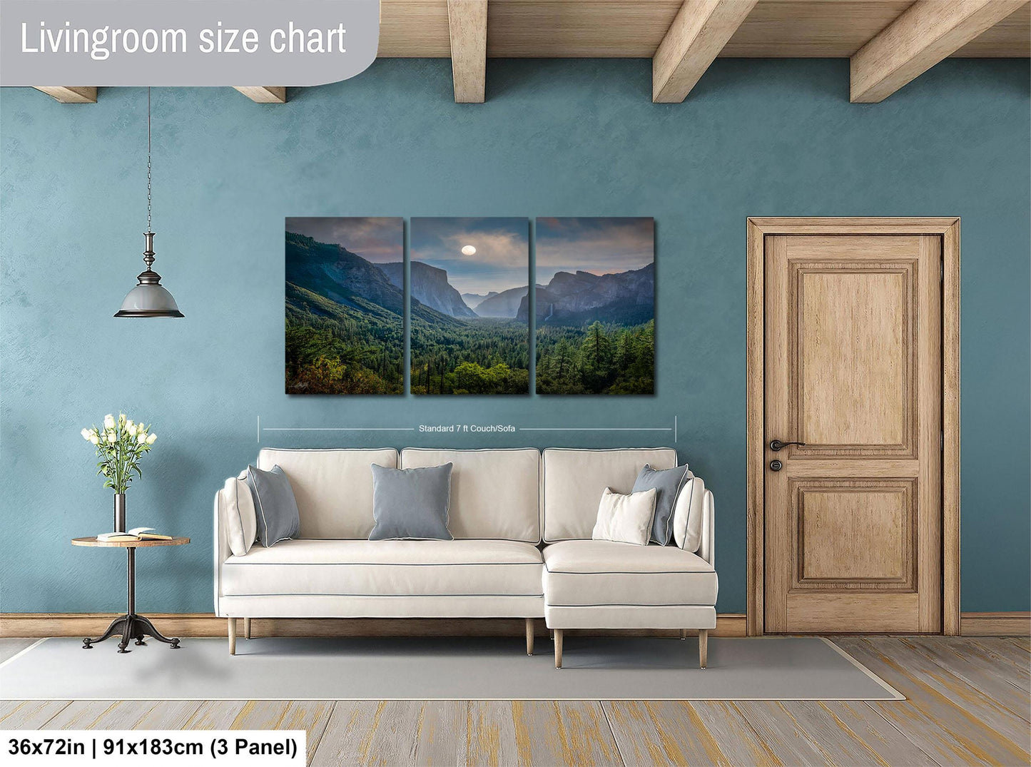 The image is a living room with a large wall art depicting a scenic mountain landscape. The wall art is divided into three panels, each showing a different part of the mountain range. The room features a white sofa, a wooden door, and a small table with a vase of flowers. The living room size chart indicates that the space is approximately 36 square meters.