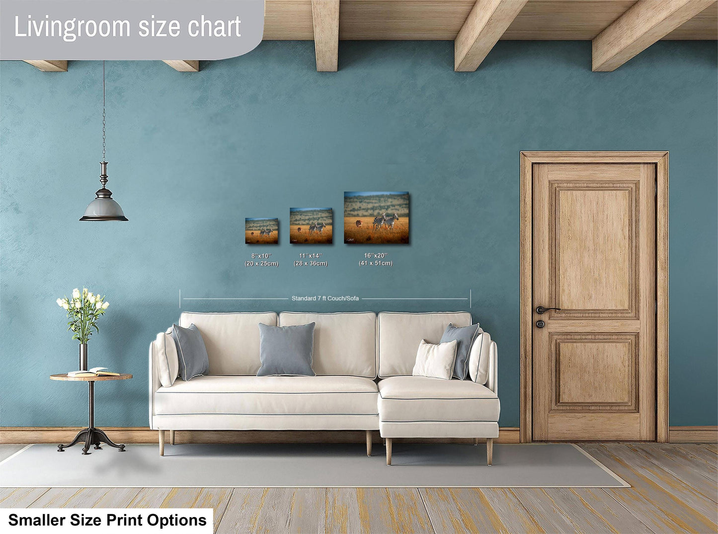 a living room with a white sofa, a wooden door, and a hanging light fixture. There are three framed artworks displayed on the wall, each varying in size. The living room appears to be designed for relaxation and comfort, with a focus on the furniture and decor.