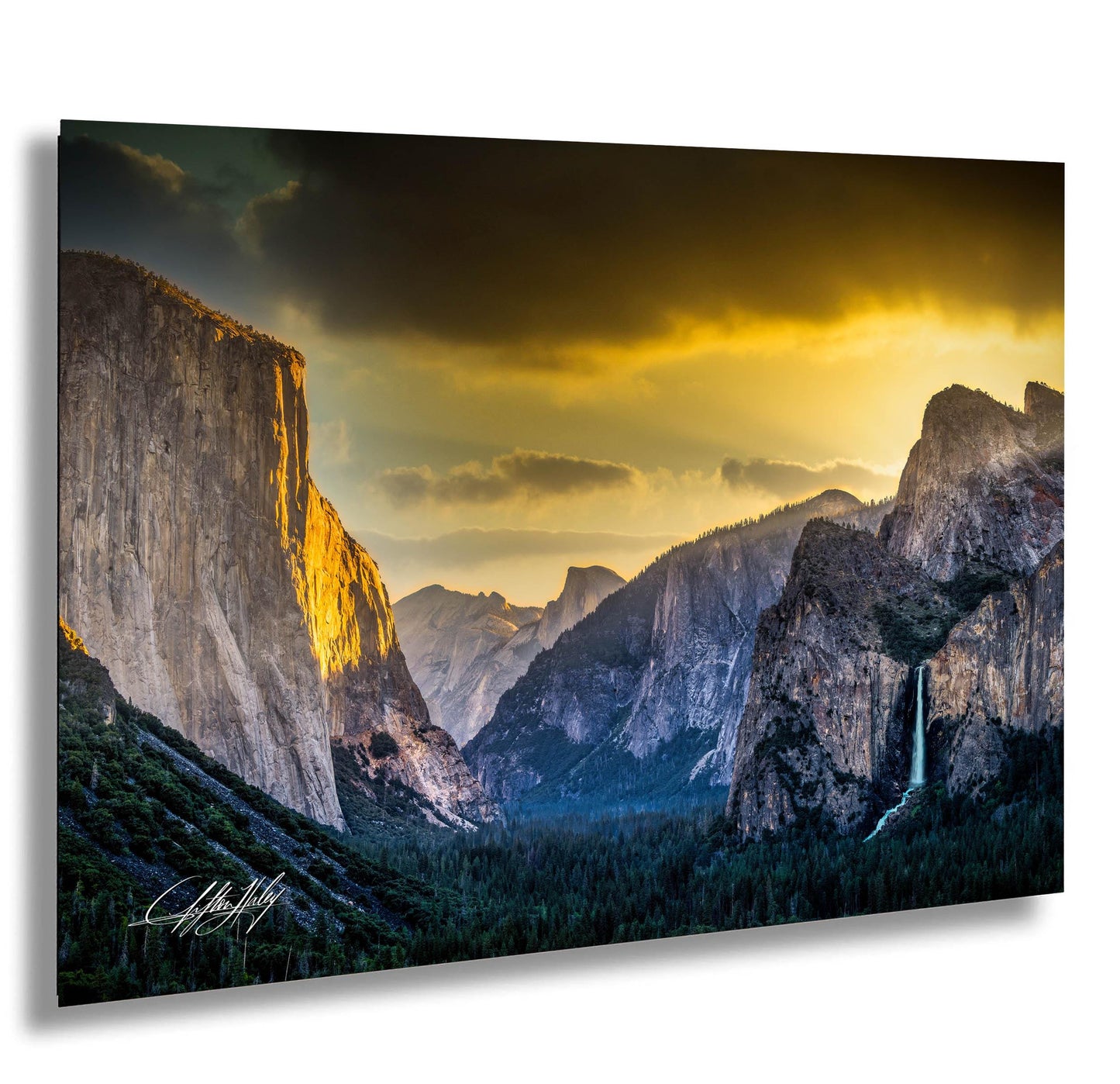 a breathtaking view of a mountainous landscape at sunset, with towering cliffs and a cascading waterfall.