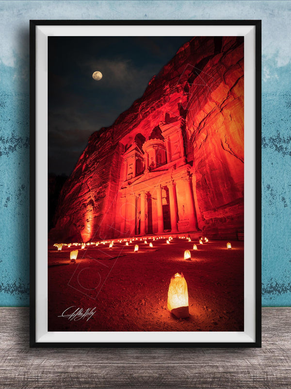 a large, illuminated building with a prominent dome, surrounded by a large number of lit candles, creating a warm and inviting atmosphere.