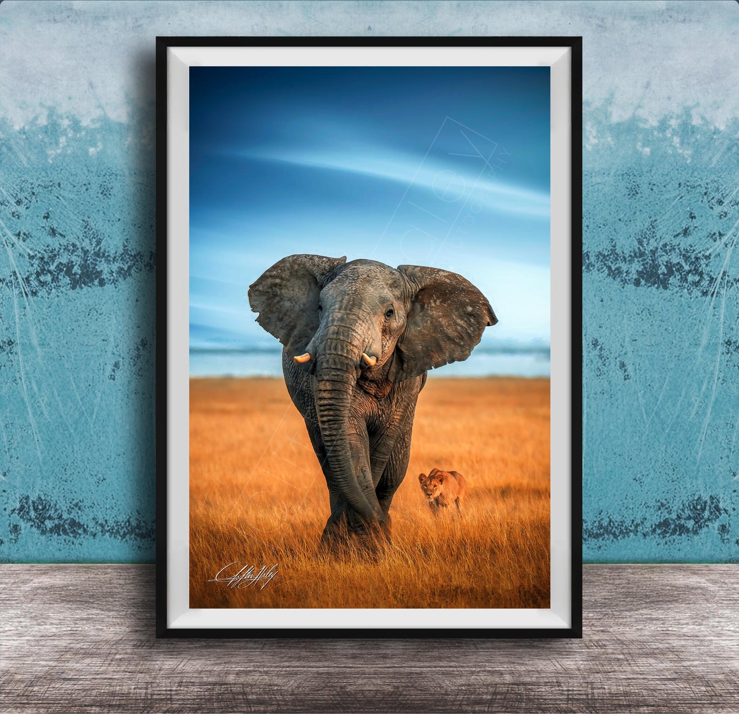 A majestic elephant stands in a golden field, its large ears flapping gently in the breeze, with a lion standing nearby.