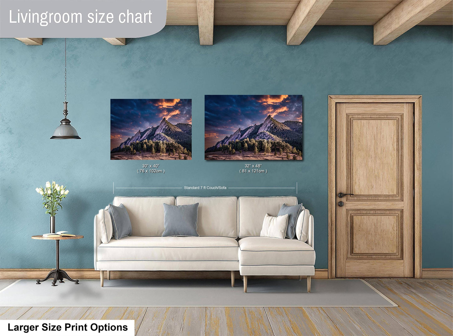 a living room with a white sofa and a wooden door. Above the sofa, there is a size chart for a painting of a mountain landscape, indicating the dimensions of the artwork.