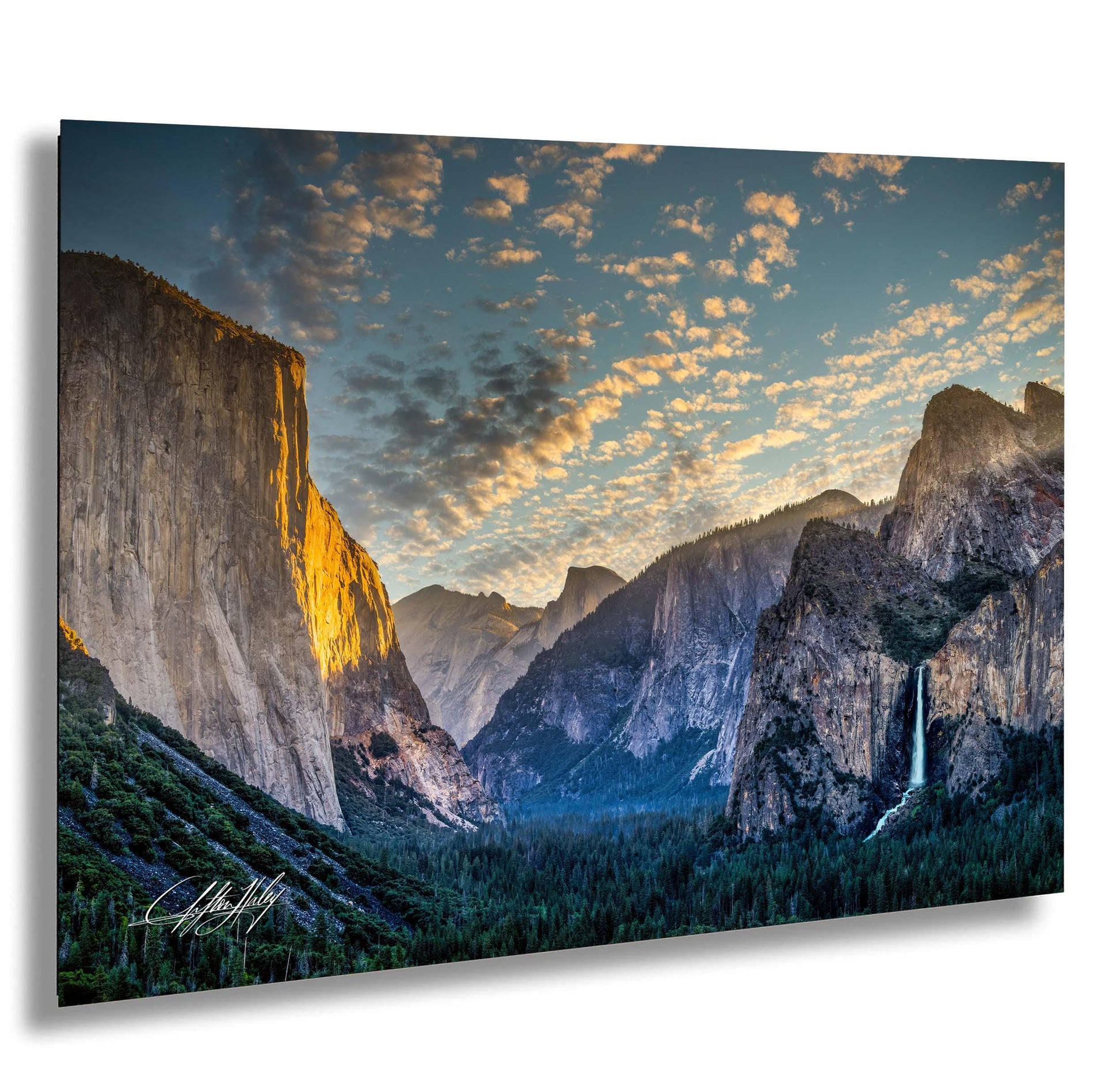 a breathtaking view of a mountainous landscape at sunset, with towering cliffs and a cascading waterfall.
