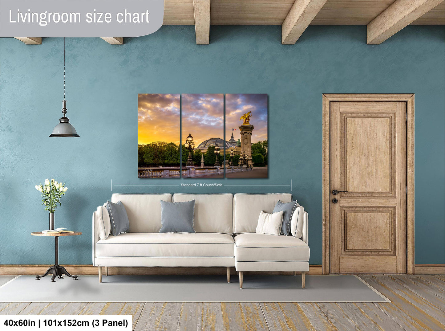 The image is a living room with a large, three-panel living room size chart on the wall. The chart displays the dimensions of the living room in centimeters, with the largest panel being 40x60 inches (101x152 cm) and the smallest panel being 40x60 inches (101x152 cm). The living room also includes a white sofa, a wooden door, and a vase of flowers on a table.