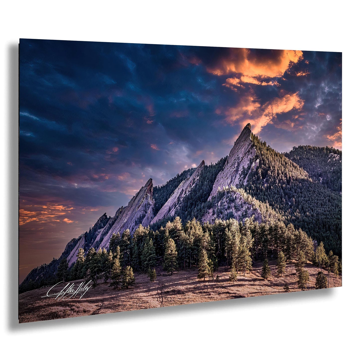 a breathtaking mountain landscape with dramatic clouds and a vibrant sunset sky.