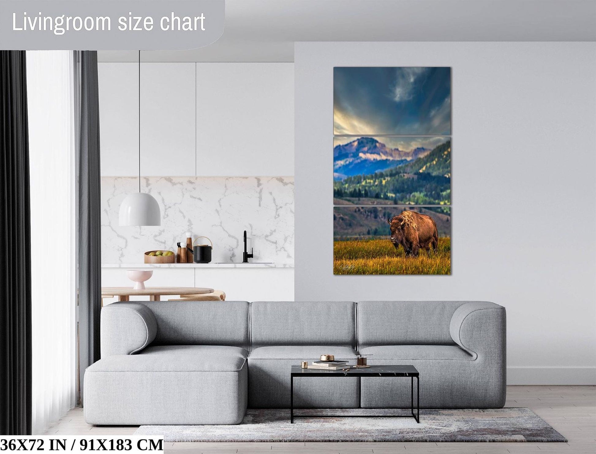 a living room with a gray sofa, a coffee table, and a large painting of a bison in a grassy field.